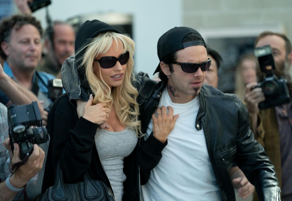 Pamela Anderson (Lily James) and Tommy Lee (Sebastian Stan) escape the paparazzi in Pam &amp; Tommy